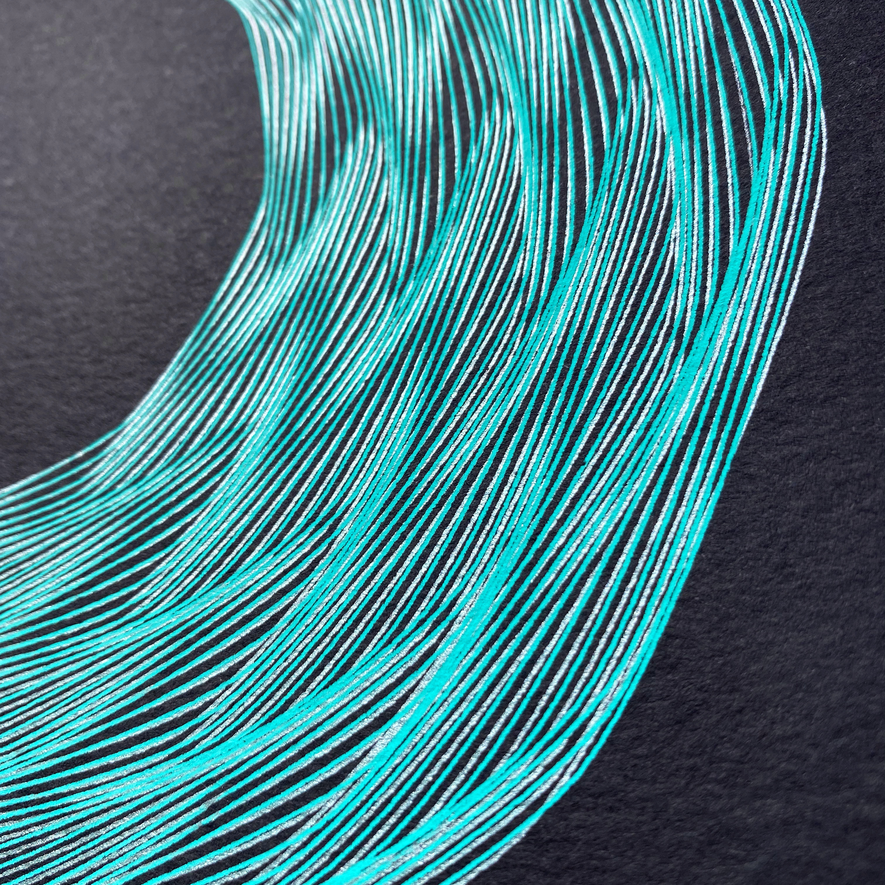 A detail photo of generative art which is made of overlapping lines in silver and metallic green on black paper.